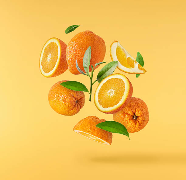 istock Fresh juicy orange slices floating on a vibrant yellow background. Creative citrus levitation concept for healthy food, summer vibes, advertising, packaging, and design projects. 2249686671
