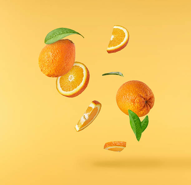 istock Fresh juicy orange slices floating on a vibrant yellow background. Creative citrus levitation concept for healthy food, summer vibes, advertising, packaging, and design projects. 2249686673