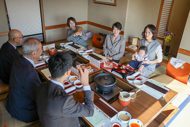 istock A group of people are sitting around a table with food and drinks 2249687136