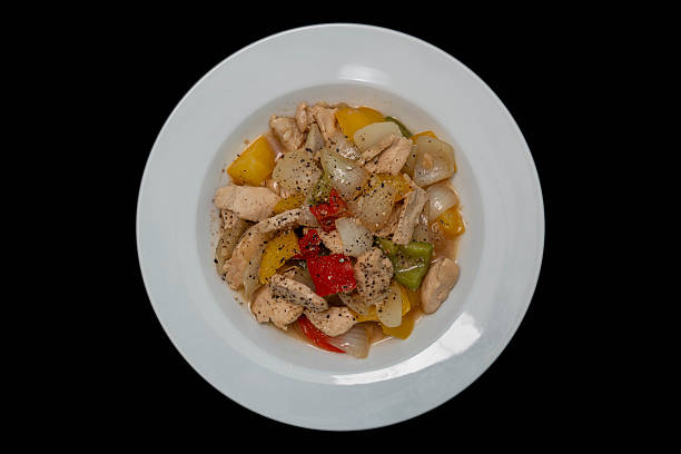 istock Stir-fried Chicken with Bell Peppers and Black Pepper on isolated black background, Top view. 2249688004