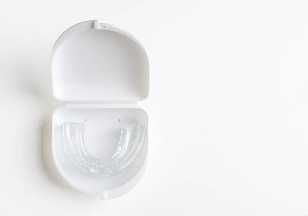 istock Anti snoring mouth guard made of reusable silicone shown on a white table or blue backdrop. The device is displayed from a side view or top view, clean and minimal, medical product style 2249688082