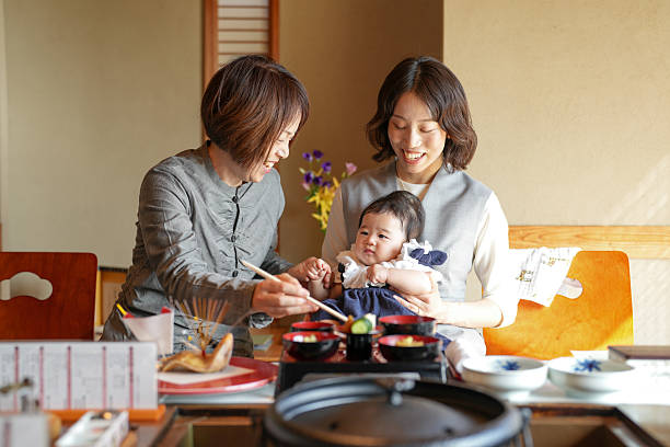 istock A woman is feeding a baby with chopsticks 2249689949