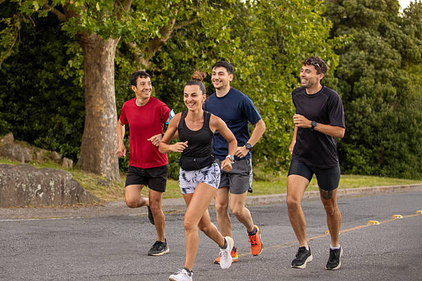 istock Group of running friends running in a public park 2249690607