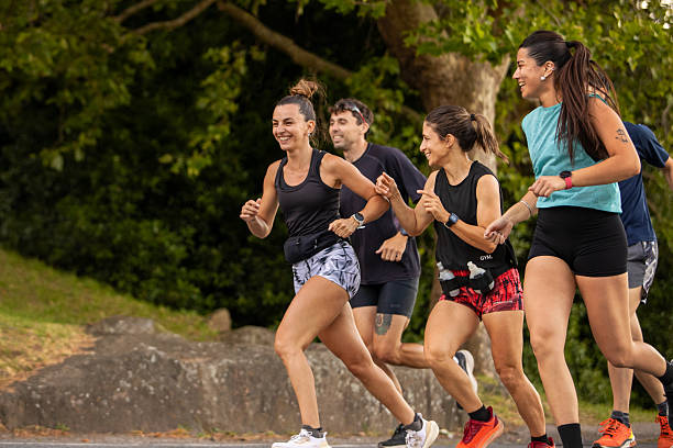 istock Group of running friends running in a public park 2249690871
