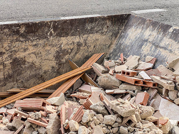 High angle close-up shot of an industrial garbage container with lots of rubble in it from construction site