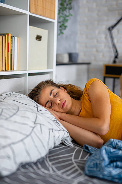 istock Peaceful woman sleeping in bed at night 2249691136