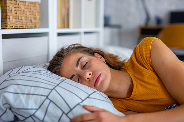 istock Peaceful woman sleeping in bed at night 2249691273