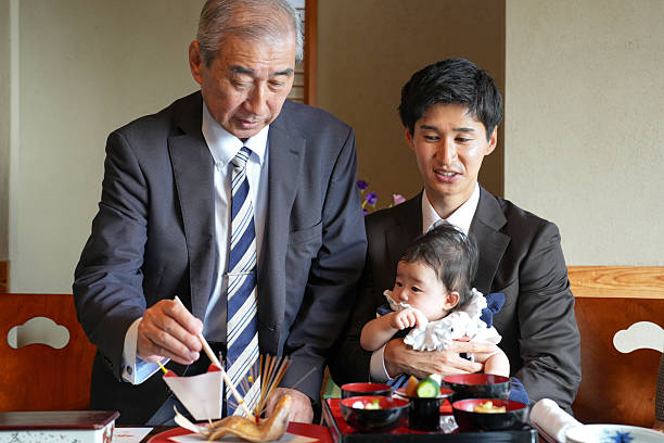 istock A man is feeding a baby with chopsticks 2249691599