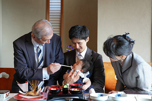 istock A man feeds a baby with chopsticks 2249691711
