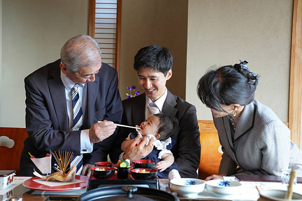 istock A man feeds a baby while a woman watches 2249691798
