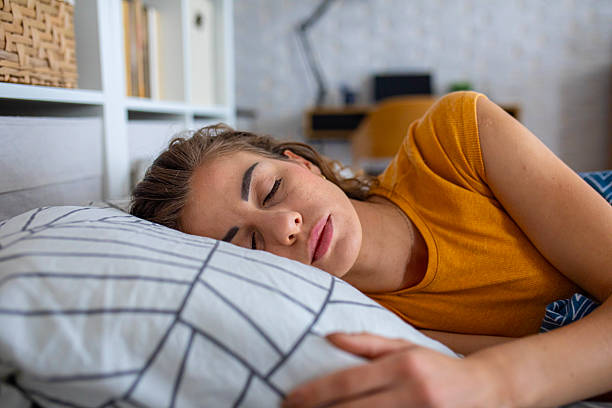 istock Peaceful woman sleeping in bed at night 2249692069