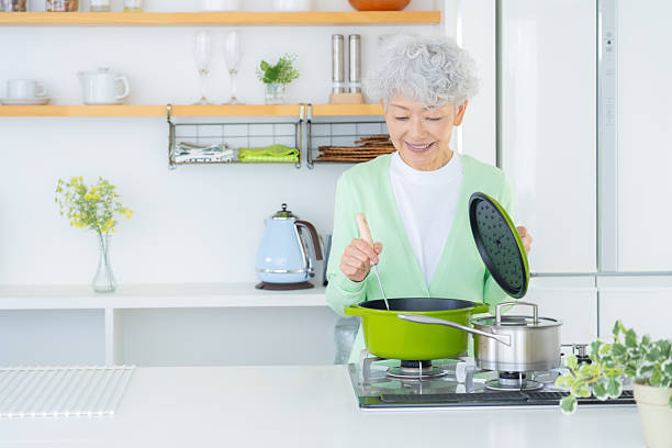 istock Senior woman doing housework in the kitchen 2249692074