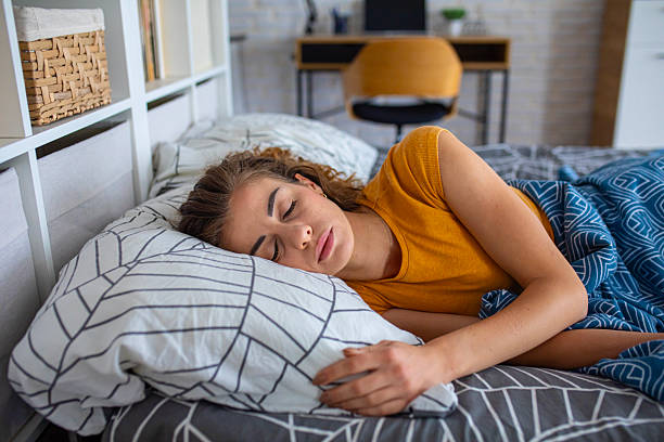 istock Peaceful woman sleeping in bed at night 2249692107