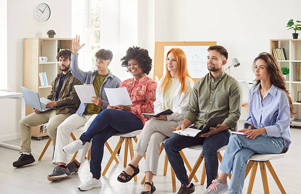 istock Business Team Asking Questions And Raising Hands During Office Meeting 2249692948