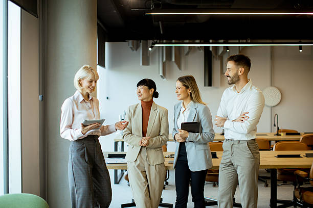 istock Business team discusses project ideas in modern office space during daytime meeting 2249693179