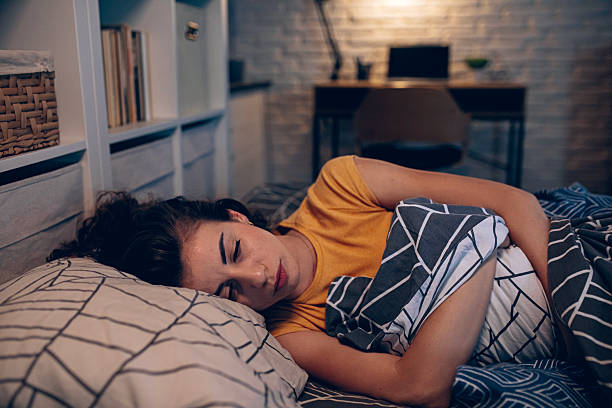 istock Exhausted woman resting in bed, unable to fall asleep 2249693385