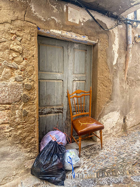 istock Abandoned chair and garbage bags next to door 2249694393