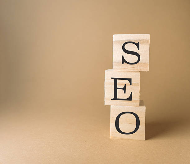 istock Stacked wooden blocks displaying letters SEO on a neutral background with soft lighting effects 2249697398