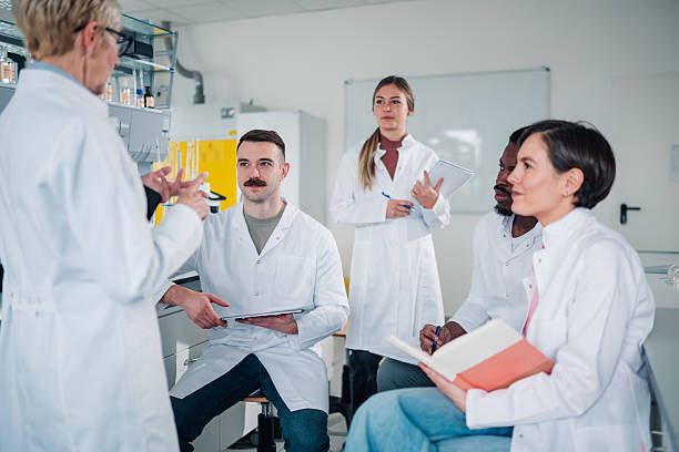 istock Diverse research team listening to group leader in laboratory 2249698149