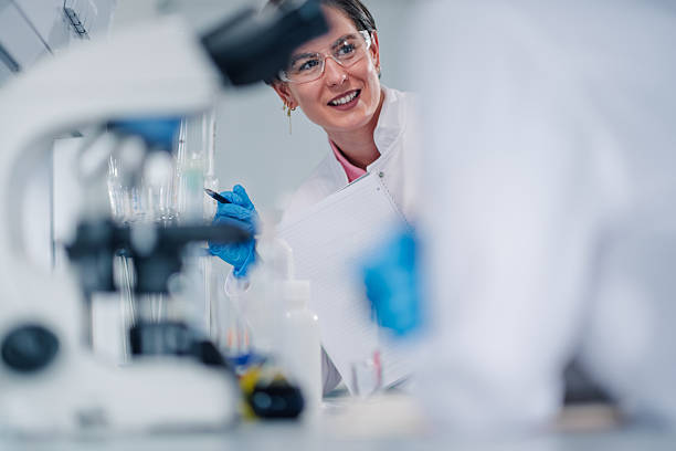 istock Female scientist working in modern laboratory smiling researching 2249698166