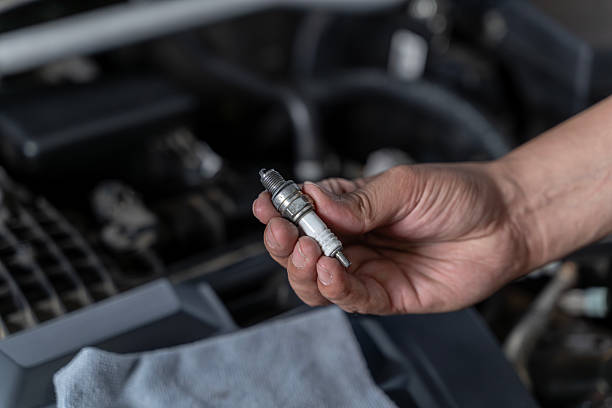 istock Close-Up Hand Holding a Spark Plug for Car Maintenance and Repair 2249698549