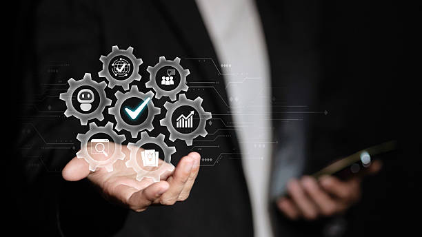 istock Businessman holding virtual gears with AI automation and business process optimization icons 2249701335