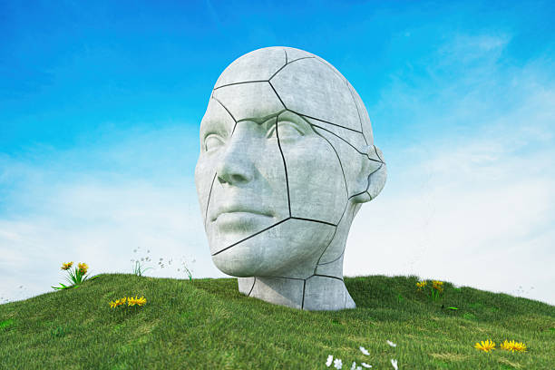 Cracked Stone Human Head Sculpture on Green Grass Hill Background. 3D Render