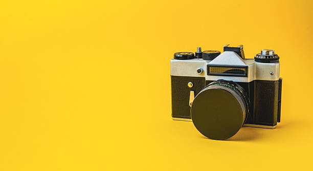 istock Vintage camera on a bright yellow background, showcasing classic design and photography elements 2249707002