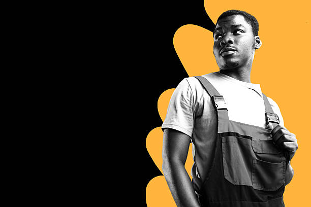 istock Young man wearing overalls poses confidently against a bright bold background 2249707872