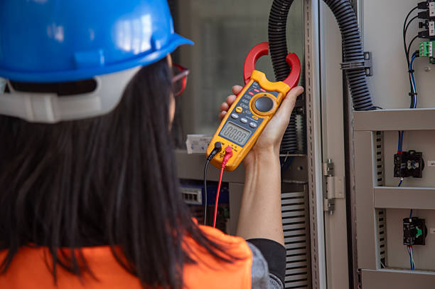 istock Female Electrical Engineer Using Digital Clamp Meter for Current Measurement in Industrial Power Control 2249707907
