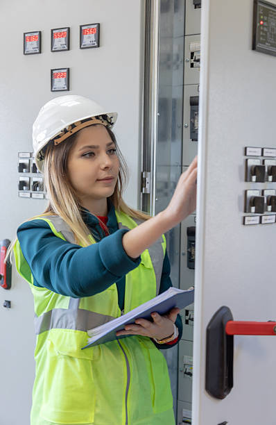 istock Female Engineer Performing Hands-On Inspection and Maintenance in Advanced Control Room of Renewable Energy Facility 2249707927