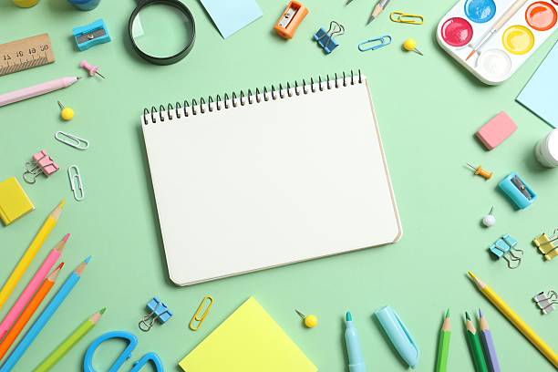 istock Open notebook with school stationery on green background, top view 2249708109
