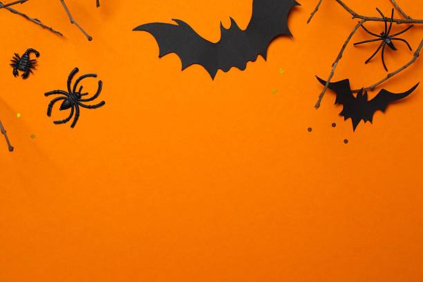 istock Halloween festive background design featuring bats, pumpkins and decorative branches. Halloween concept 2249708402