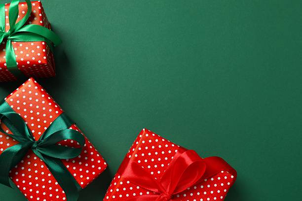 istock Festive gift boxes tied with bows on green background 2249708423