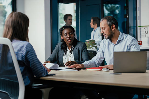 istock Black Female Manager Leading Feedback Session in Office 2249708673
