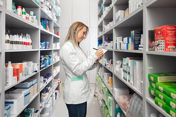 istock Pharmacist Checking Stock Levels with Clipboard in Pharmacy 2249708797