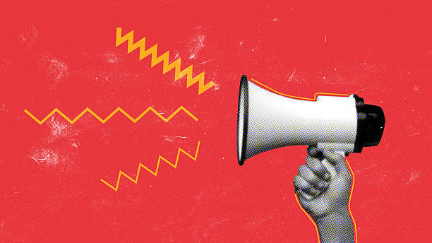 istock Hand holding a megaphone delivering a message in a vibrant setting 2249708992