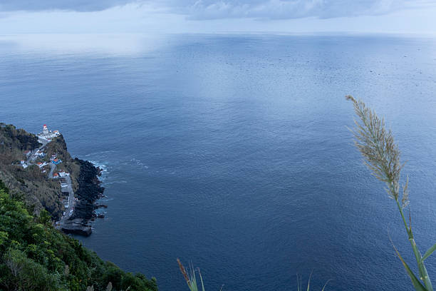 istock A lighthouse is on a cliff overlooking the ocean 2249709044