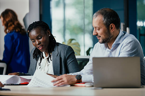 istock Confident Black Woman Leads Feedback Session Meeting in Modern Open Office 2249709828