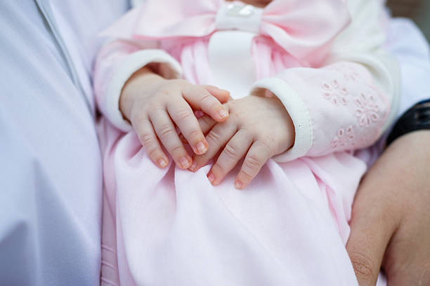 The doctor keeps the hand of a sick child. The parent is holding the child's handle.
