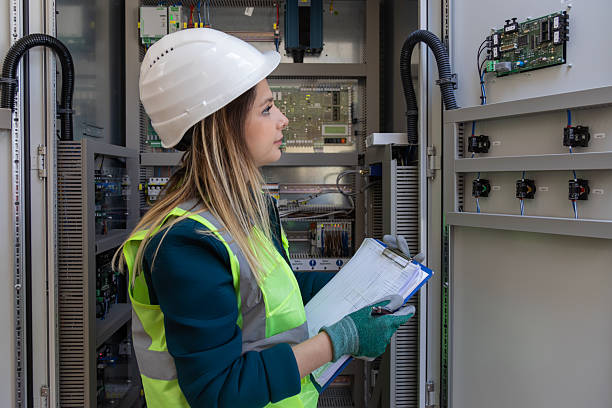 istock Female Engineer Inspecting Control Panel and Taking Notes for Safety and Maintenance at Power Station 2249710829