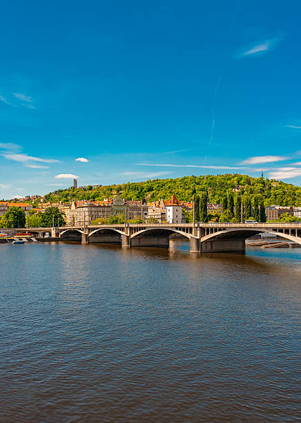 istock Jirasek Bridge. Modern bridge spanning river with historic city backdrop. 2249718334