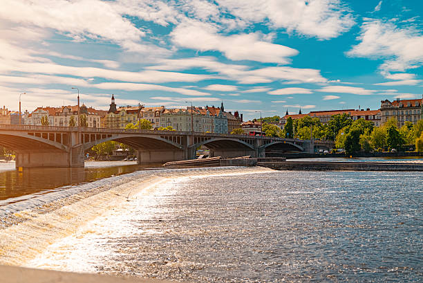 istock Dam creating small rapids on city river Vltava. 2249718352