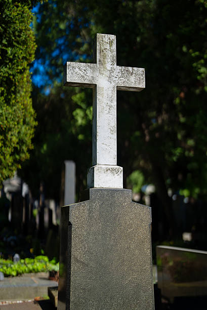 istock Memorial stone cross in the forest cemetery. 2249718407