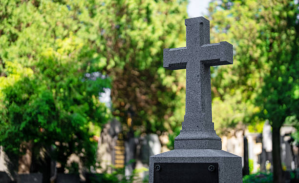 istock Memorial stone cross in the forest cemetery. 2249718409