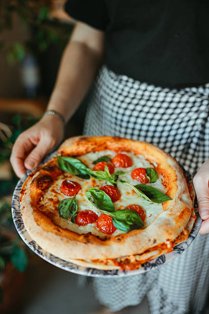istock Pizza chef serving freshly baked pizza 2249720242