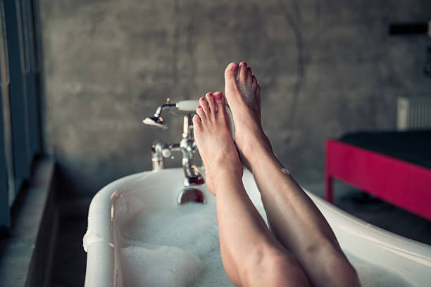 istock Woman feet in bathrobe at home, closeup 2249722027