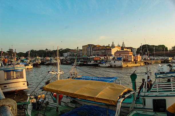 Fishing boats in the port of the Mercado Ver o Peso market, and in the background, colonial-era buildings in the city of Belém, state of Pará, northern Brazil.