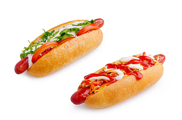 istock Delicious hot dogs with fresh toppings served on a white background 2249722773