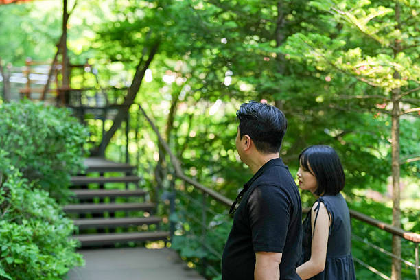 istock A man and a woman are walking on a path in a forest 2249722824